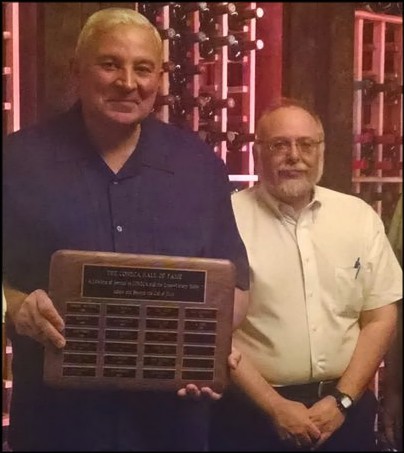 Al Raddi, left, receives CONECA Hall of Fame Award from Mark Lighterman